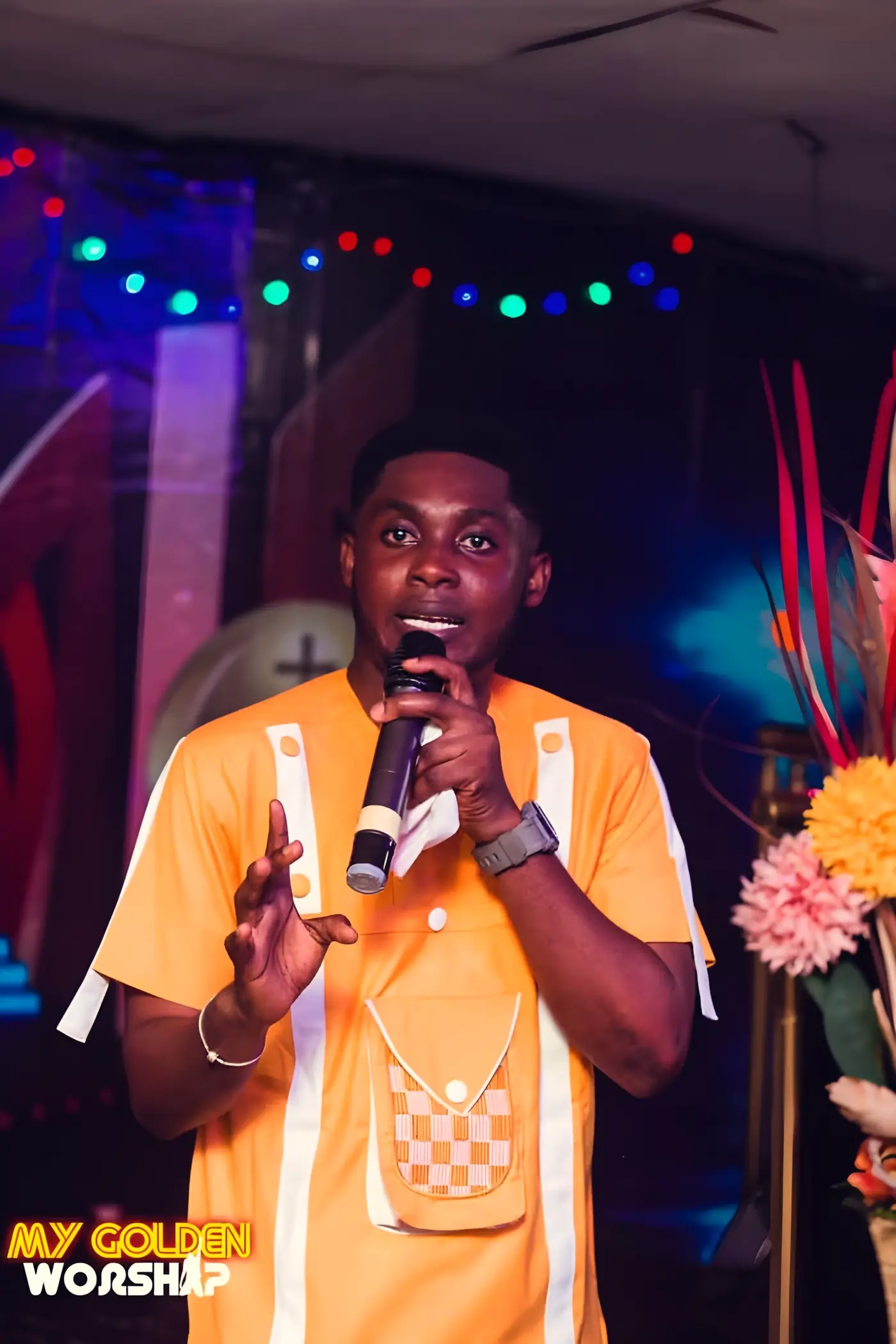 A worship leader singing at a BYM worship night