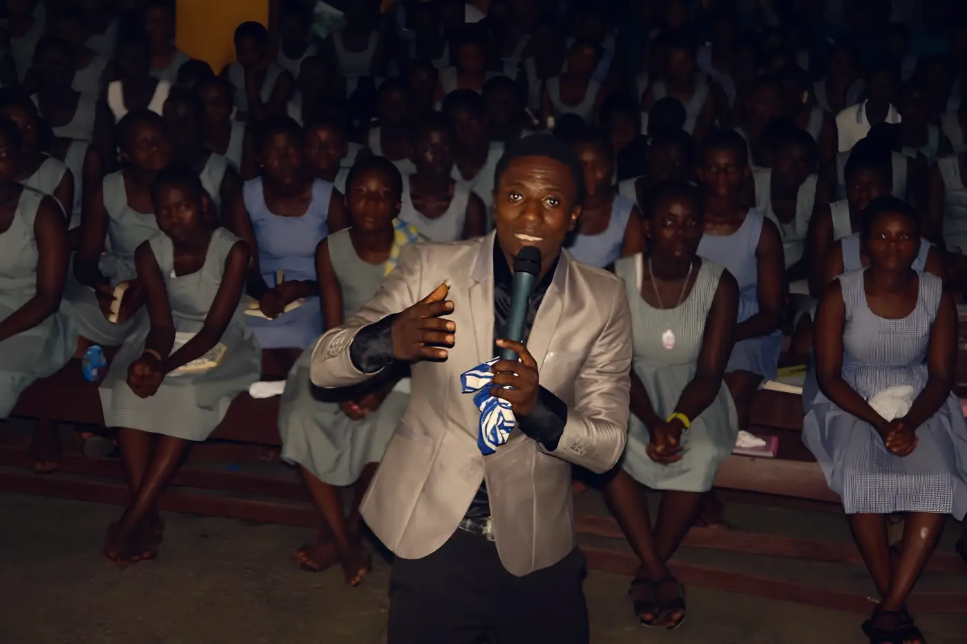 A BYM minister preaching to a hall full of students