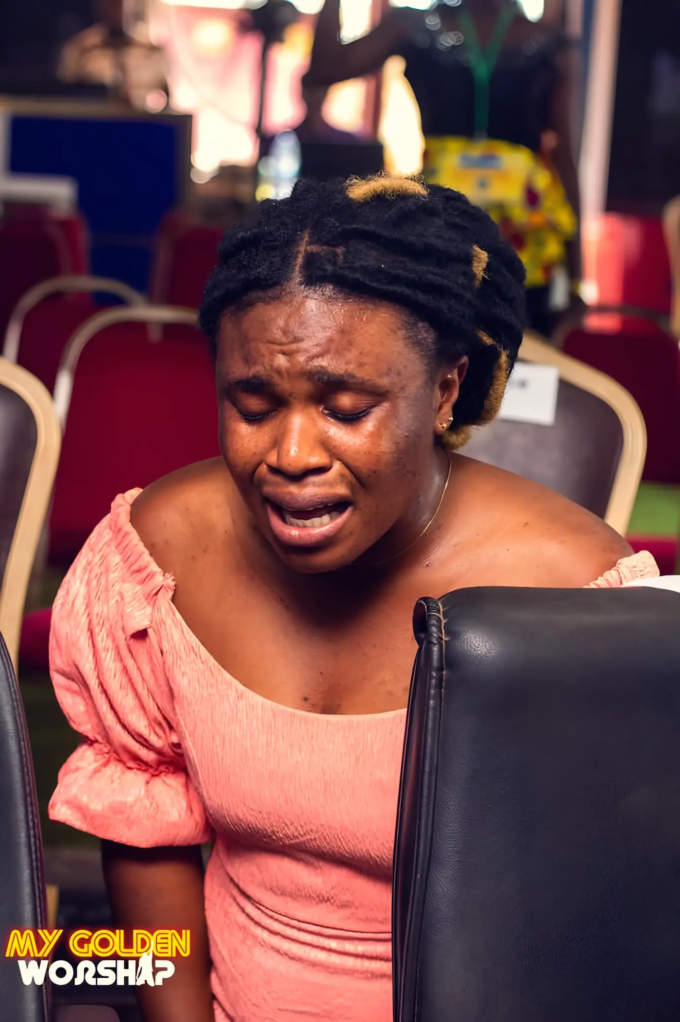 A young woman praying with her eyes closed